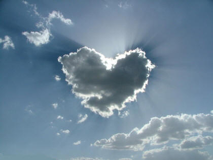 Sun behind heart-shaped cloud