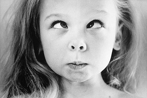 Little girl making funny cute cross-eyed face