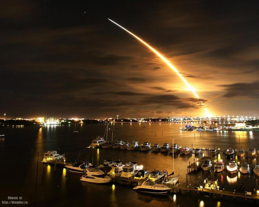 Rocket taking off at night over city